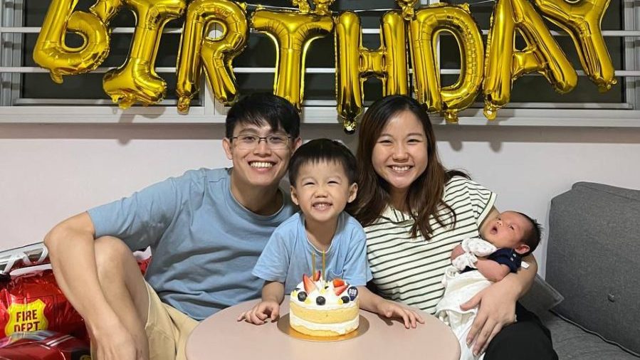 An Asian family celebrating their son's birthday.