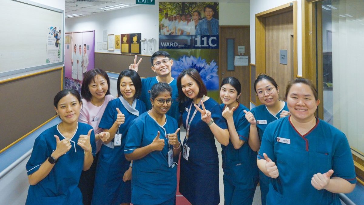 A group of healthcare workers in a ward.